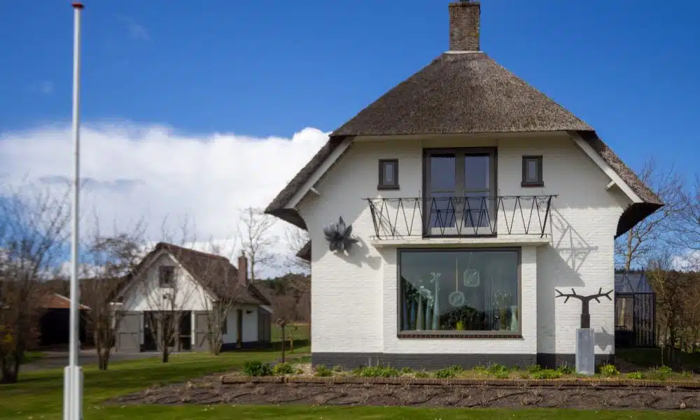 white concrete house on green grass field during daytime