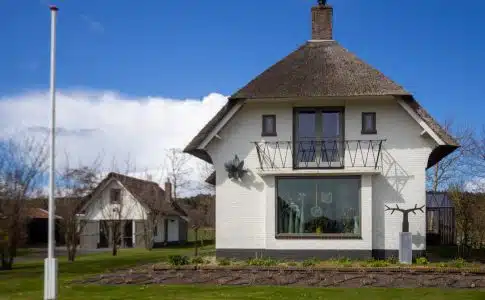 white concrete house on green grass field during daytime